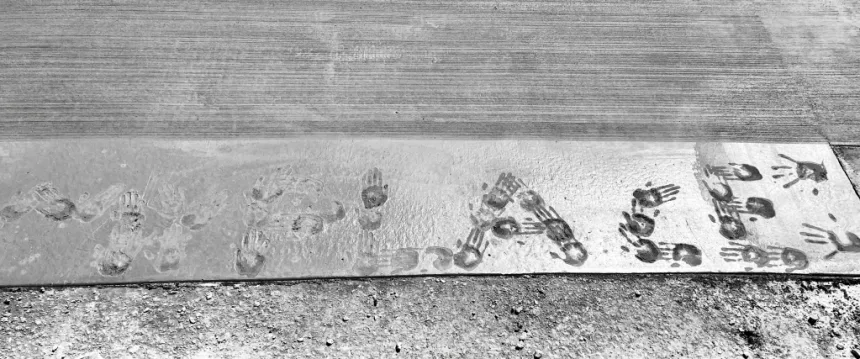 Handprints in cement spelling out 'My Place'