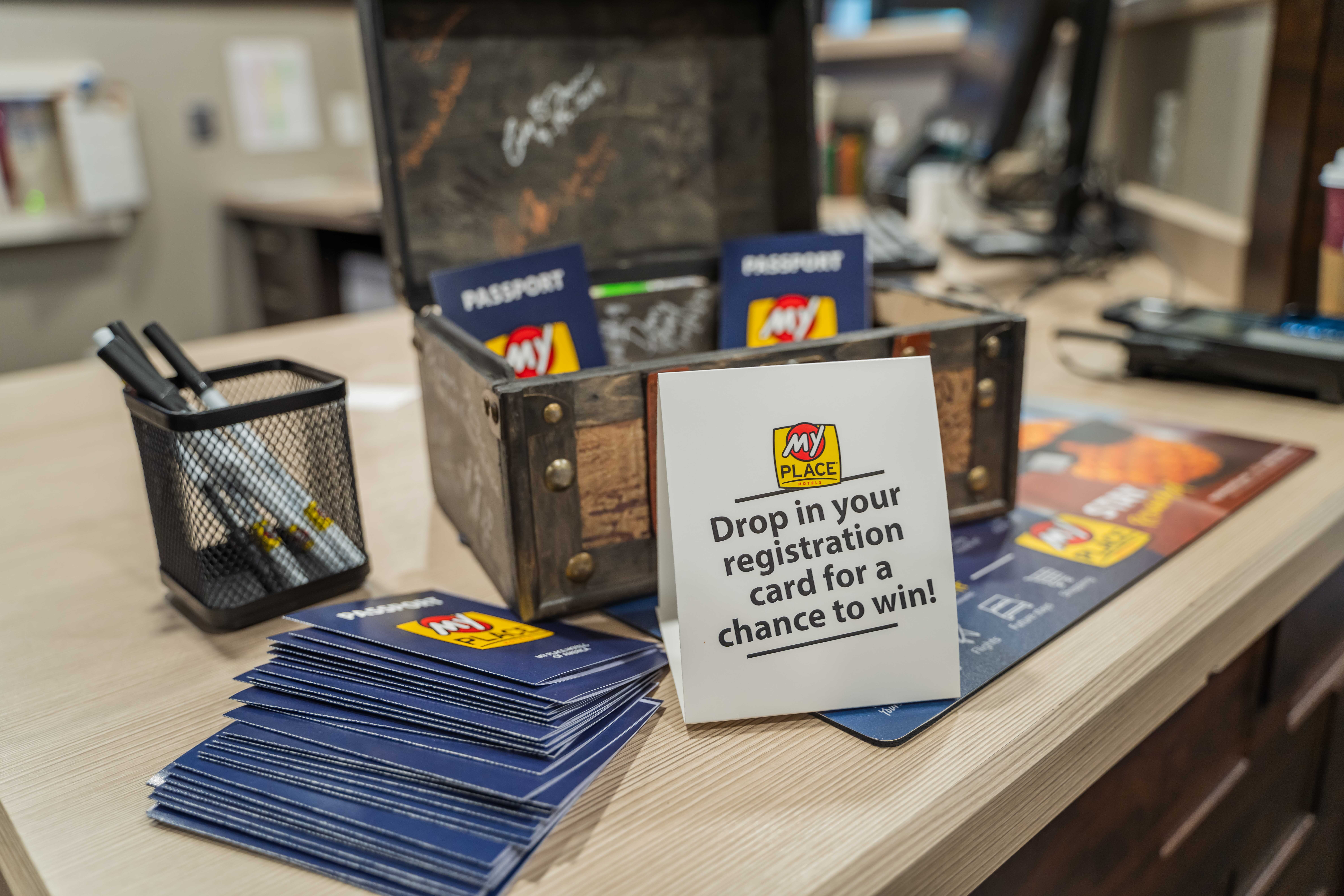 My Place Hotels passports sitting on a hotel lobby counter during a grand opening celebration