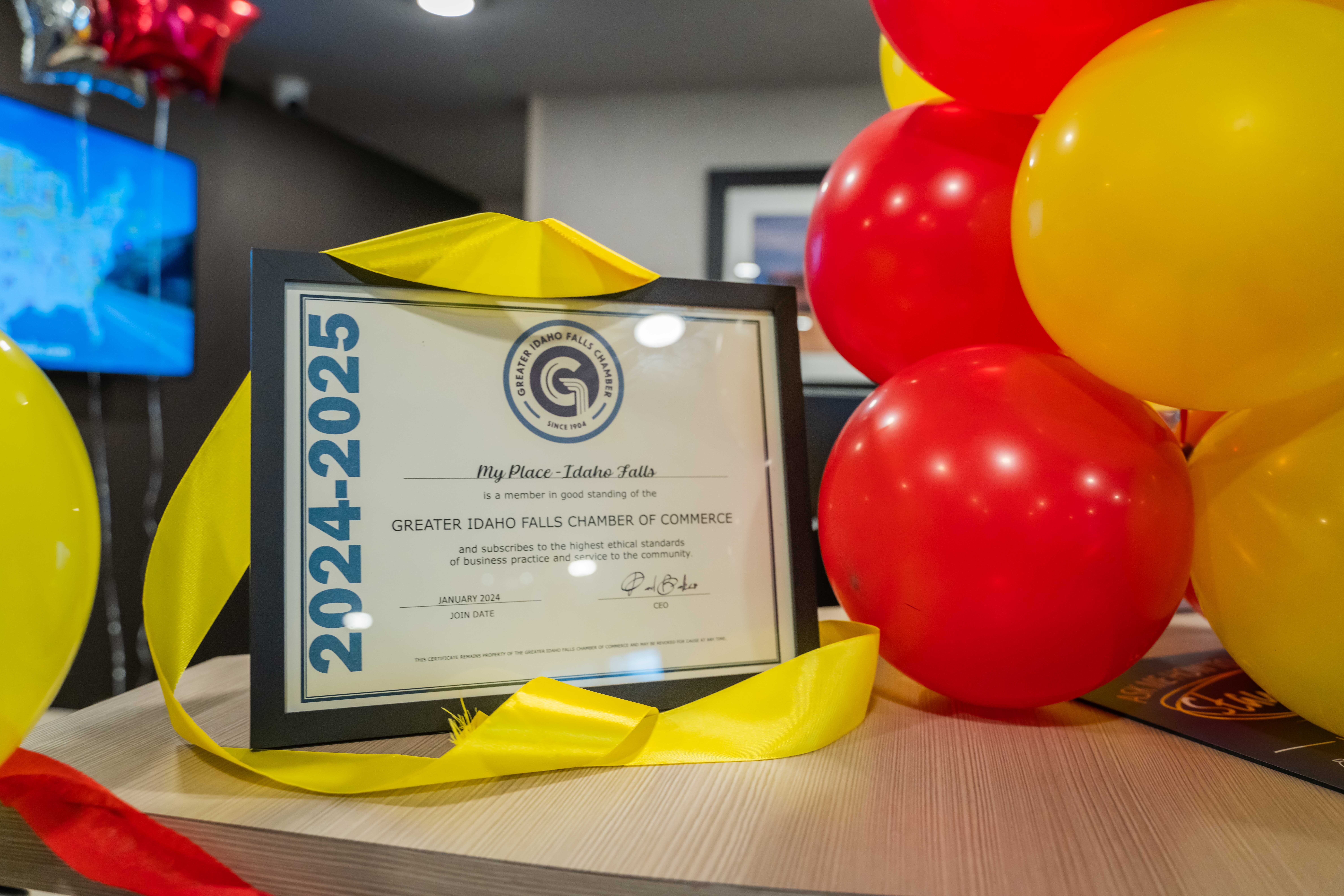 A sign from a chamber of commerce stating membership of a My Place Hotel