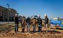 Pictured are six professionals posing in their My Place hard hats shoveling dirt.