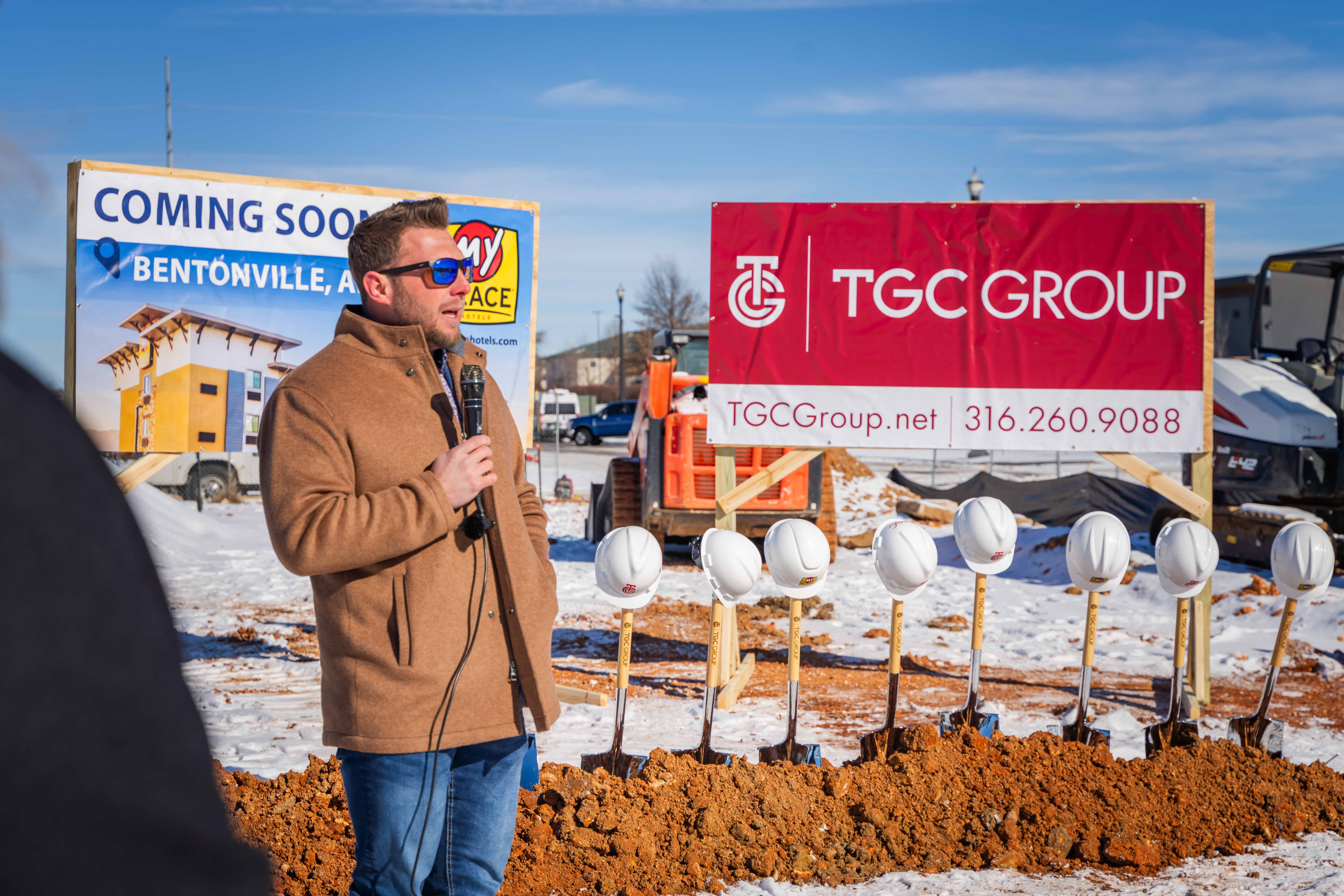 A man speaking outside at a groundbreaking event