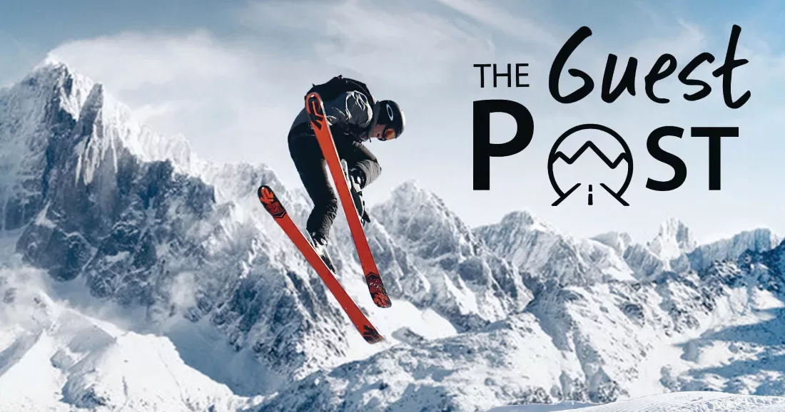A man is airborne while wearing skis with mountains in the background, with "The Guest Post" logo in the top right corner.