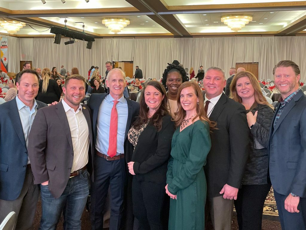 Members of the My Place team smile and pose with South Dakota governor Dennis Daugaard.