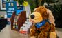 Detailed shot of the hotel front desk, which has a Pet Points stuffed animal dog set on it.