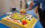 A cake being served at a grand opening celebration