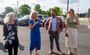 Guests are pictured having conversations in the parking lot of the new hotel, including the president of My Place, Ryan Rivett.