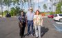 Three professionals are pictured posing outside of the new hotel in the parking lot.