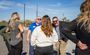 Several people talk in a group outside the new hotel in Nampa, Idaho during the hotel's grand opening celebration.