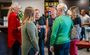 A group of women talk inside the lobby during the grand opening celebration in the new hotel in Nampa, Idaho.
