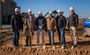 Pictured are six professionals posing in their My Place hard hats with shovels in their hands.