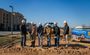 Pictured are six professionals posing in their My Place hard hats shoveling dirt.