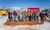 A group of people with shovels standing ready for an earth turning ceremony