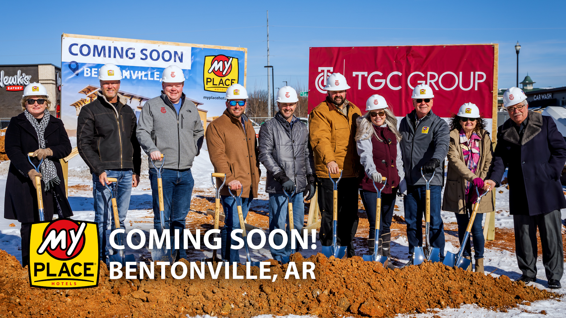 Bentonville, AR video cover showing ten people wearing white hard hats and holding shovels.