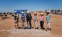 Six professionals holding shovels, scooping up dirt for the groundbreaking event!