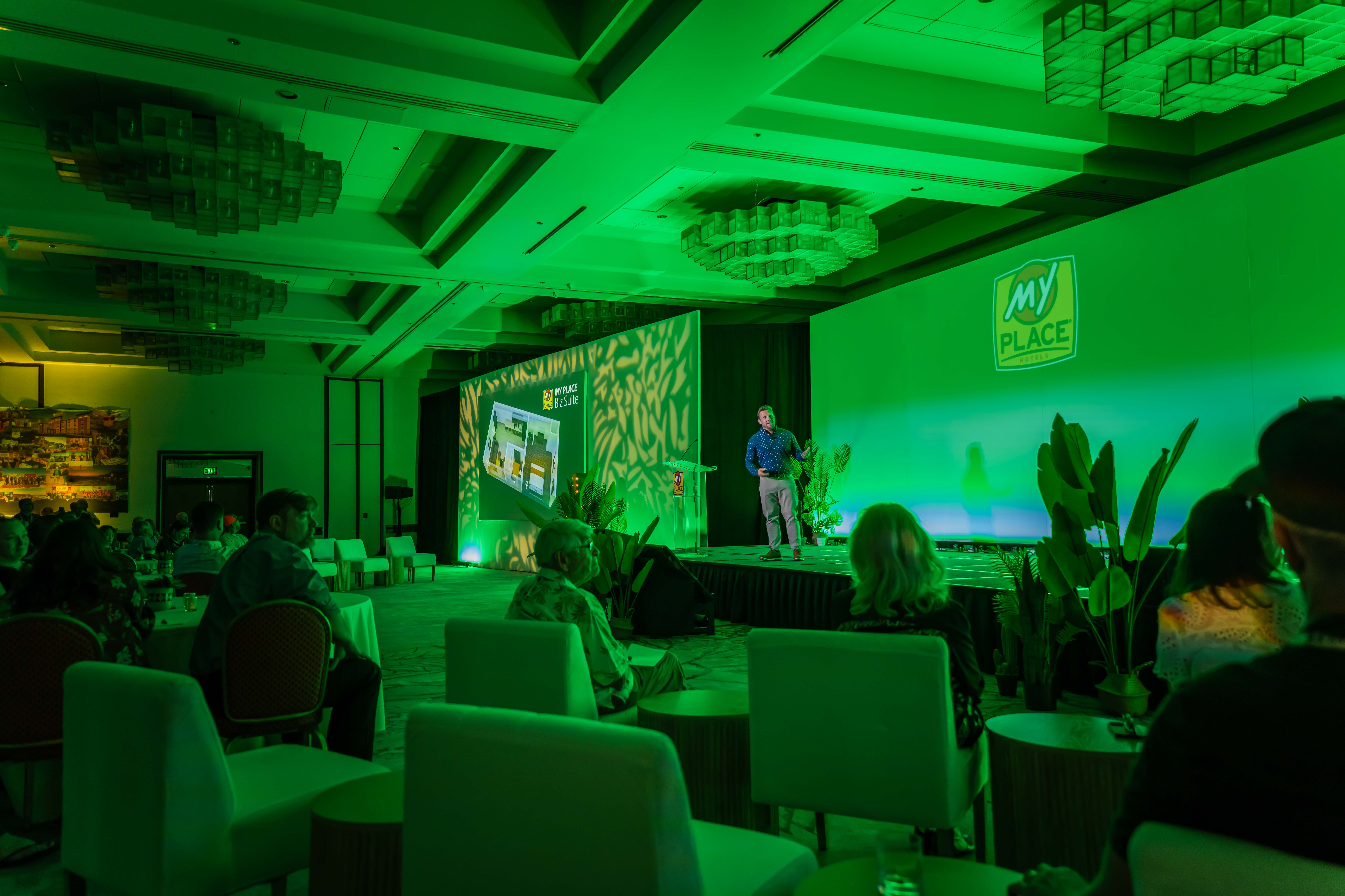 A man presenting to a group of people at a hospitality conference
