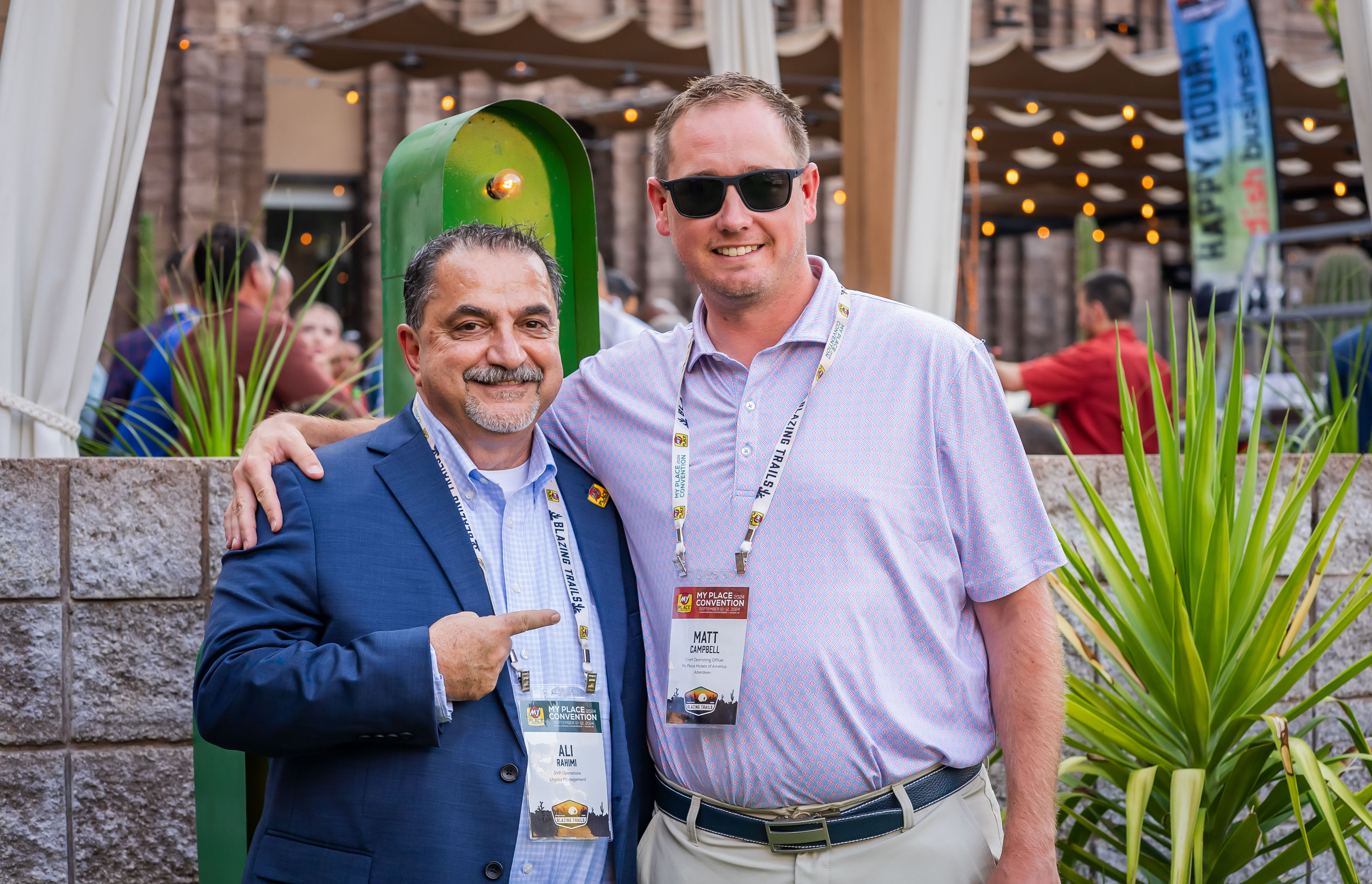 Two men smiling for the camera at a networking event