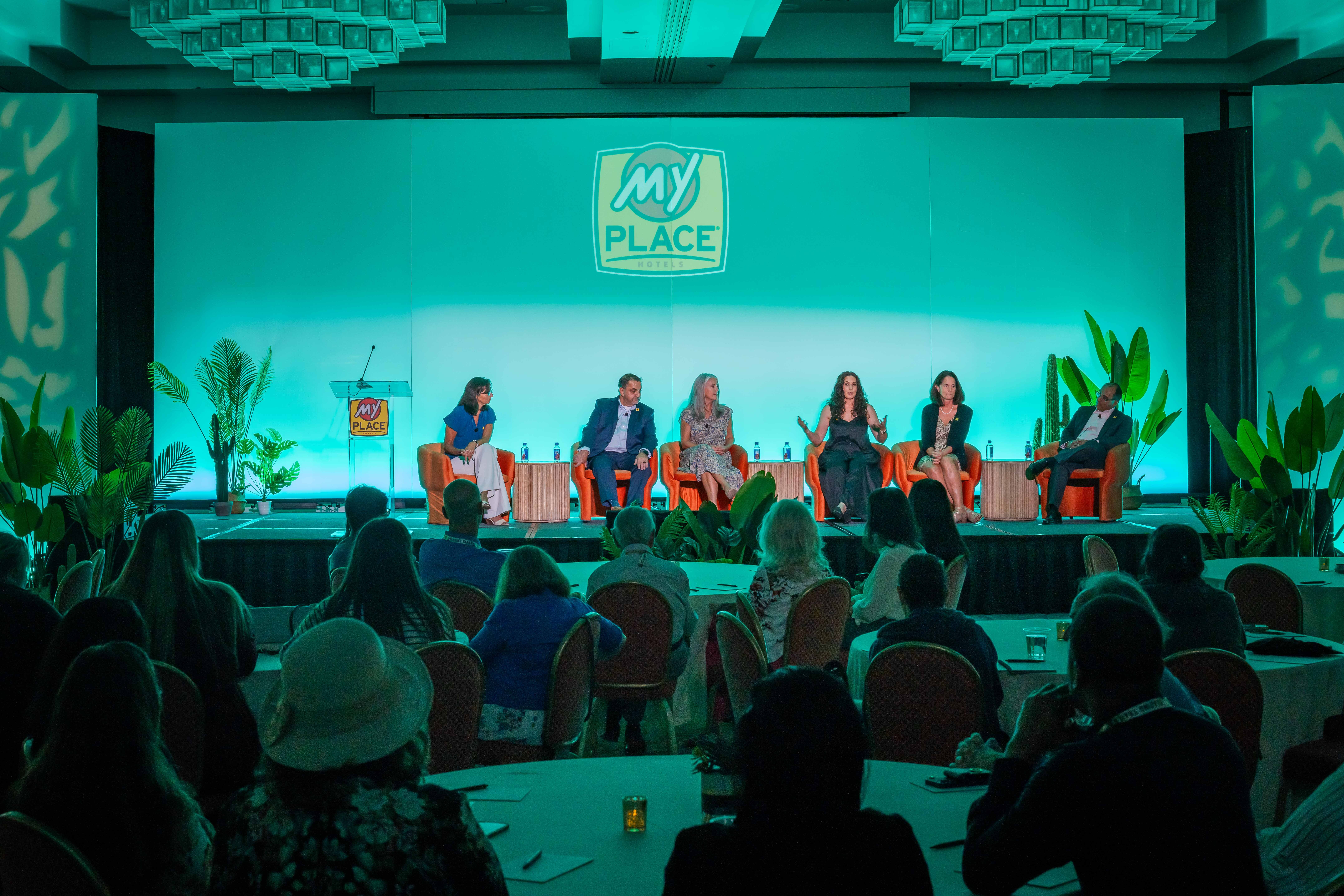 A panel of hospitality experts speaking at a conference