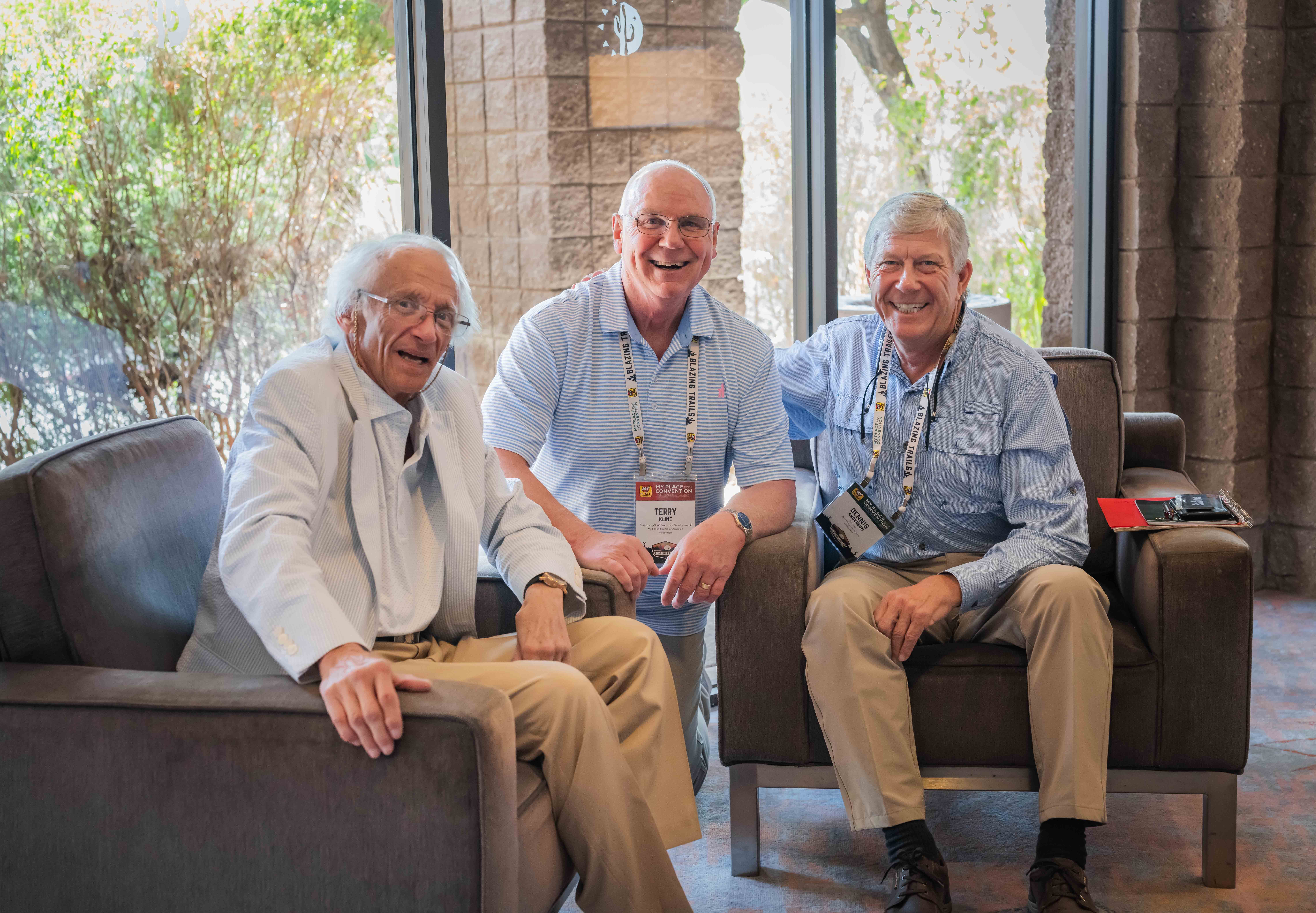 Three men smiling for a photo