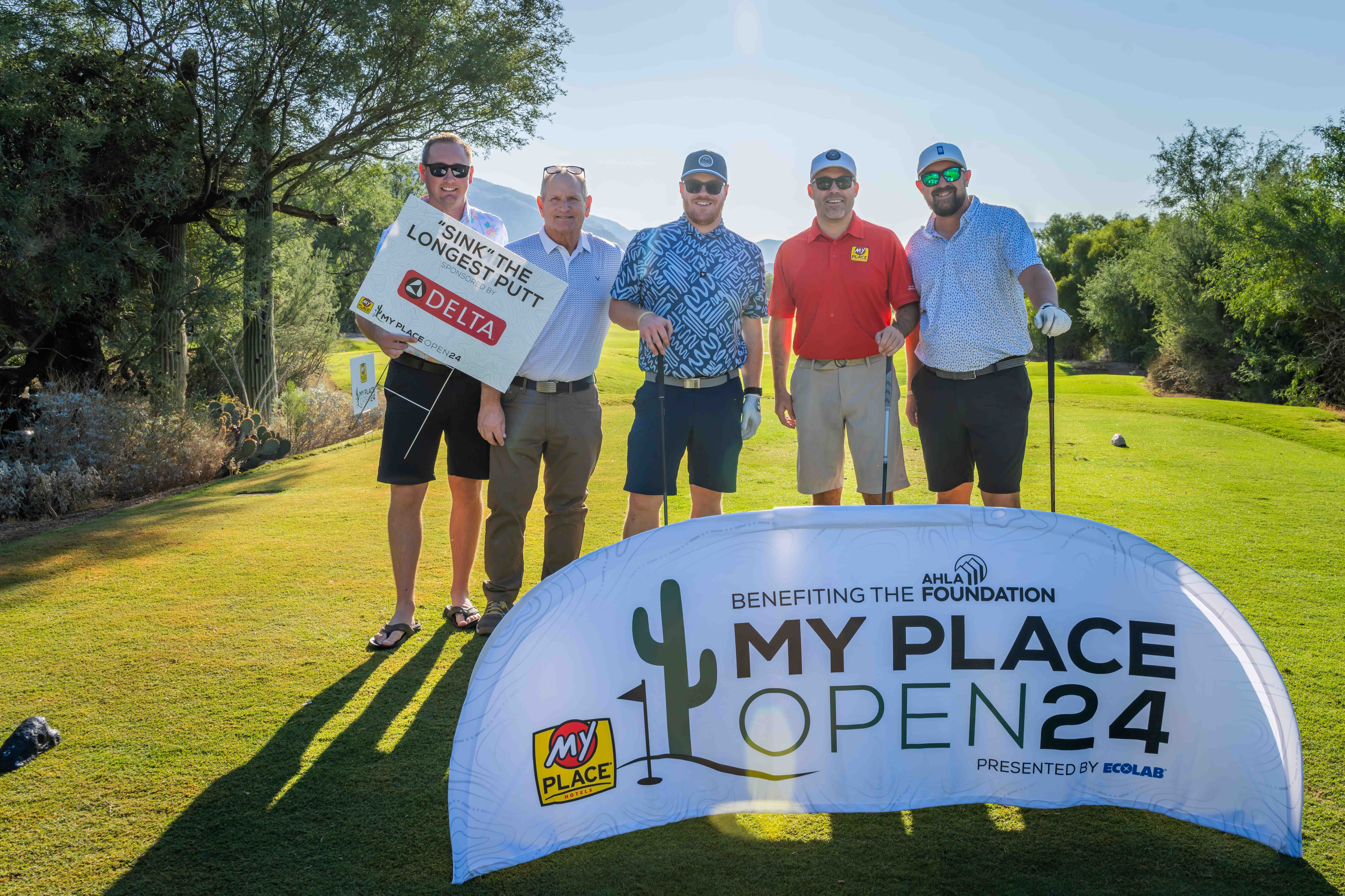 A group of golfers posing for a photo