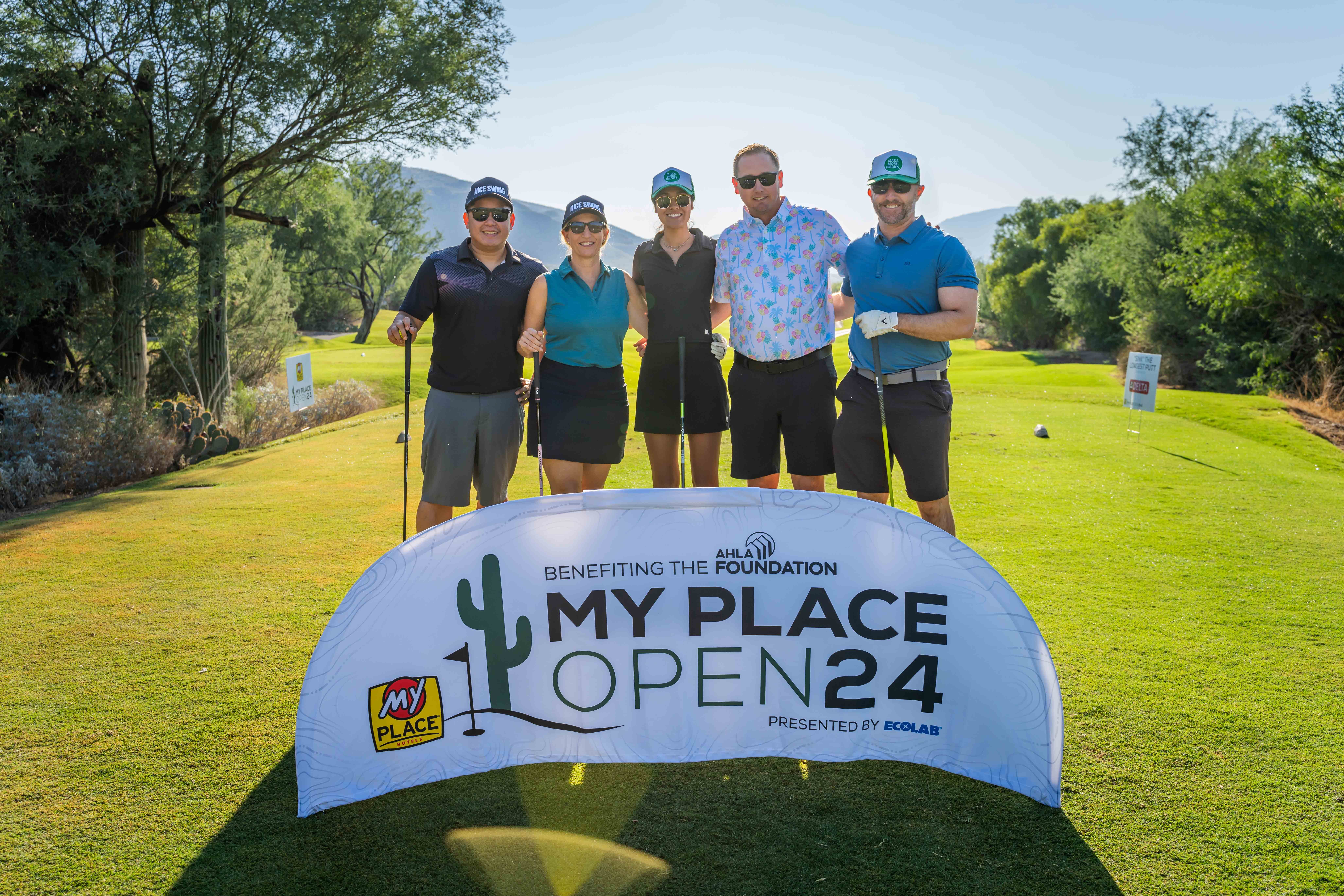 A group of golfers posing for a photo
