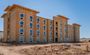 Pictured is the unfinished Mesa 4 story property, with windows and wooden walls.