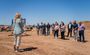 Sally Harrison, President/CEO of Mesa Chamber of Commerce is sharing a few words in front of other professionals outside at the groundbreaking.