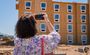 Woman is photographed taking a picture of the unfinished Mesa hotel.