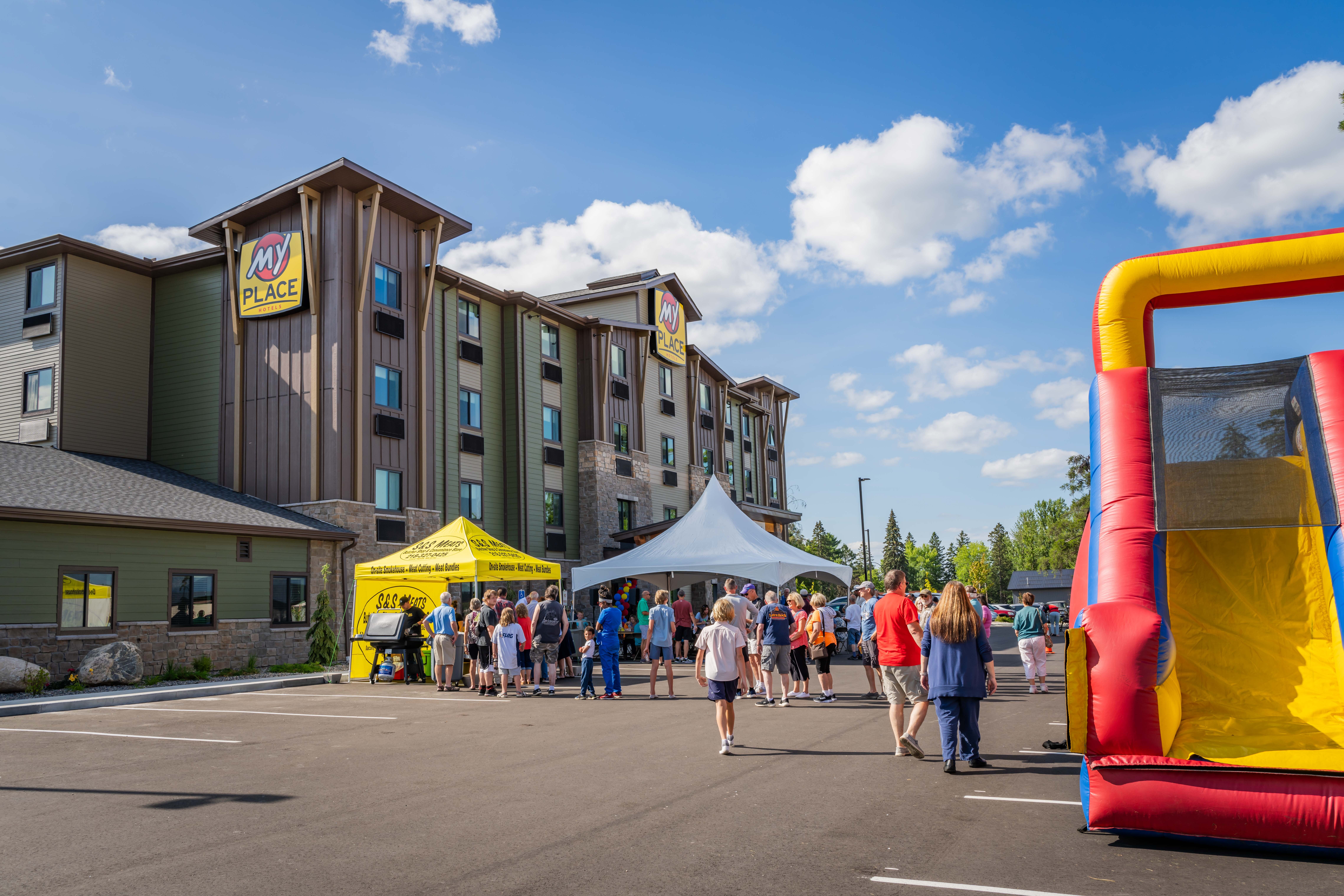 An exterior shot of a hotel during a grand opening celebration