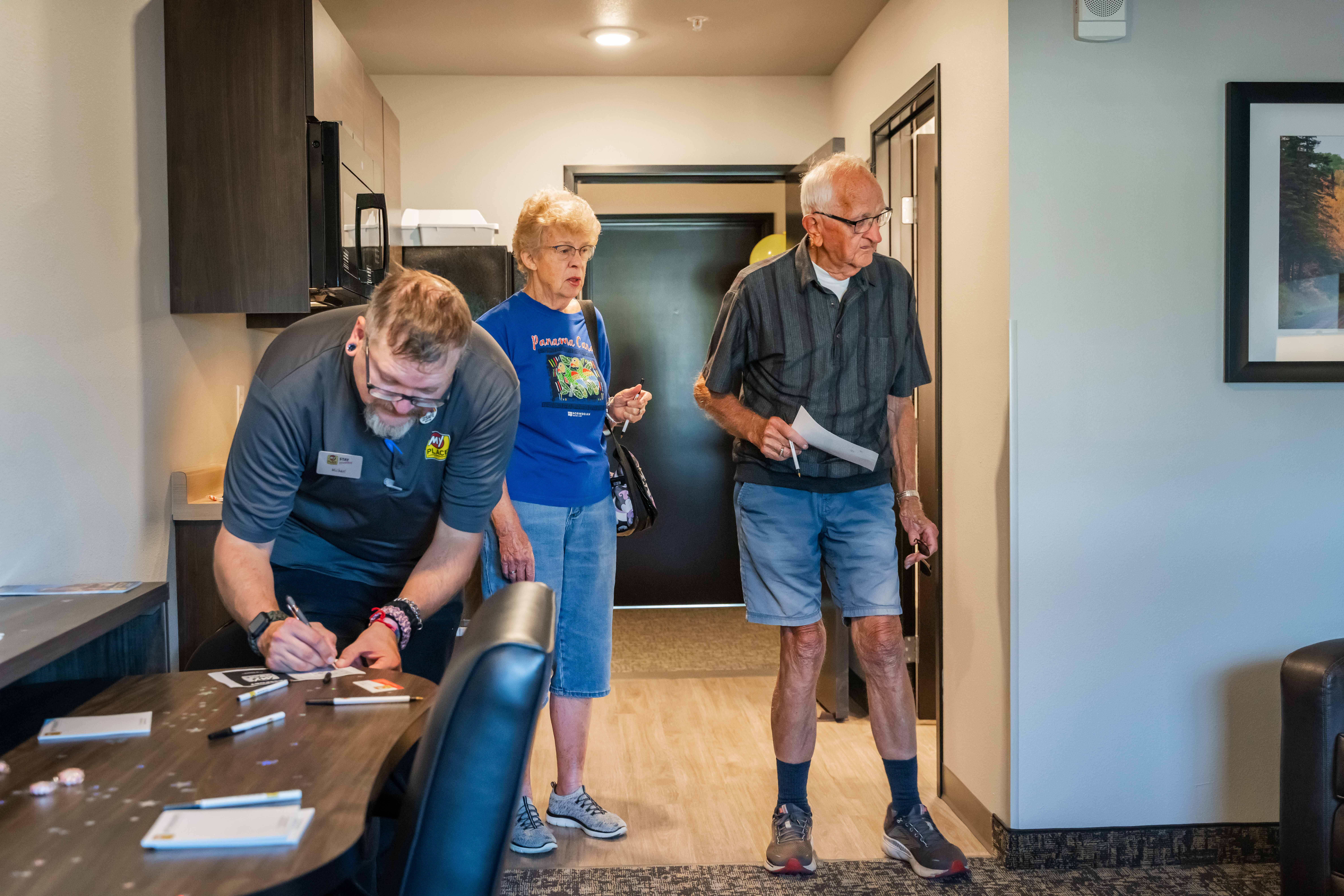 Individuals taking tours of a hotel room during a grand opening celebration