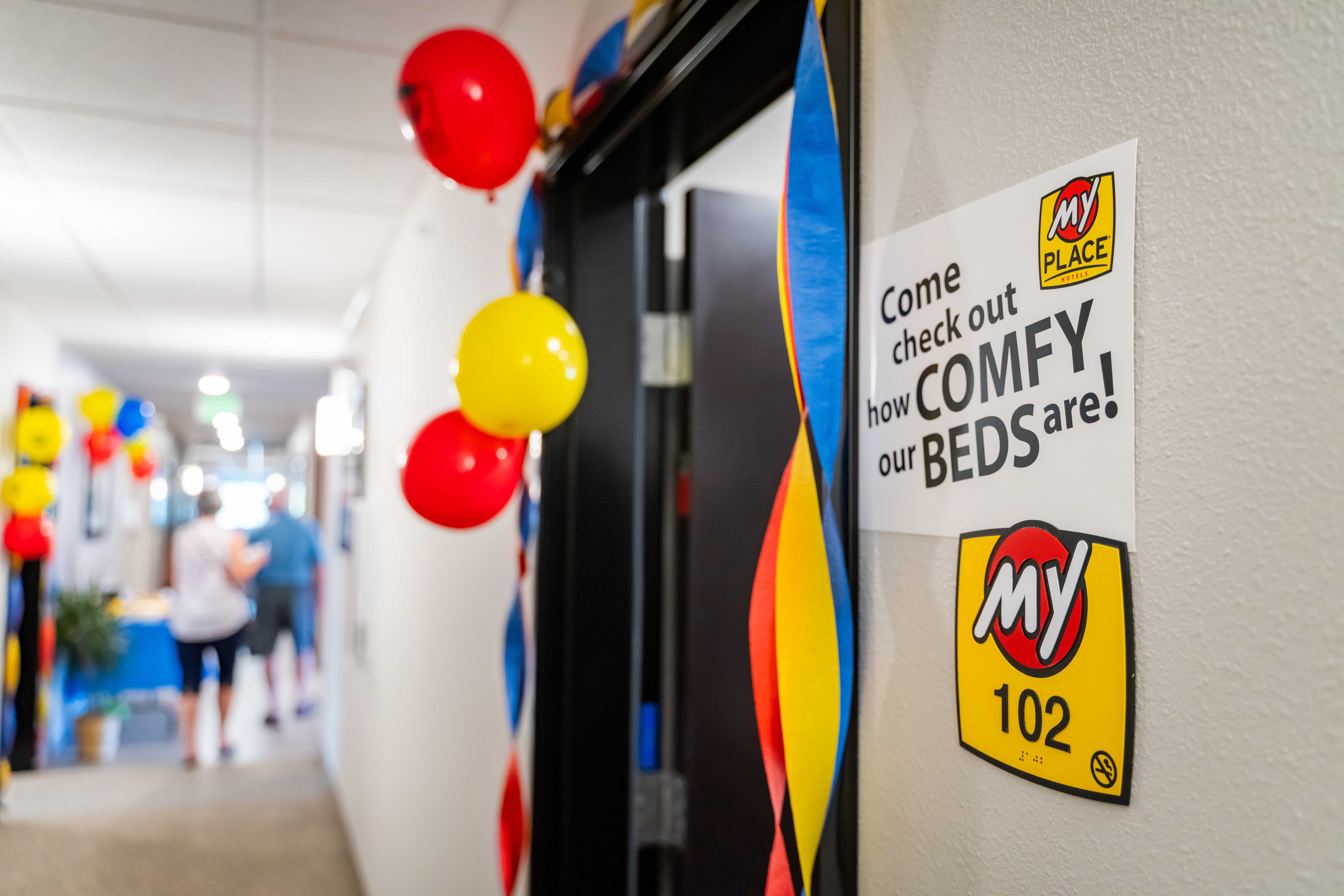 Balloons and streamers hung outside of a hotel room during a celebration