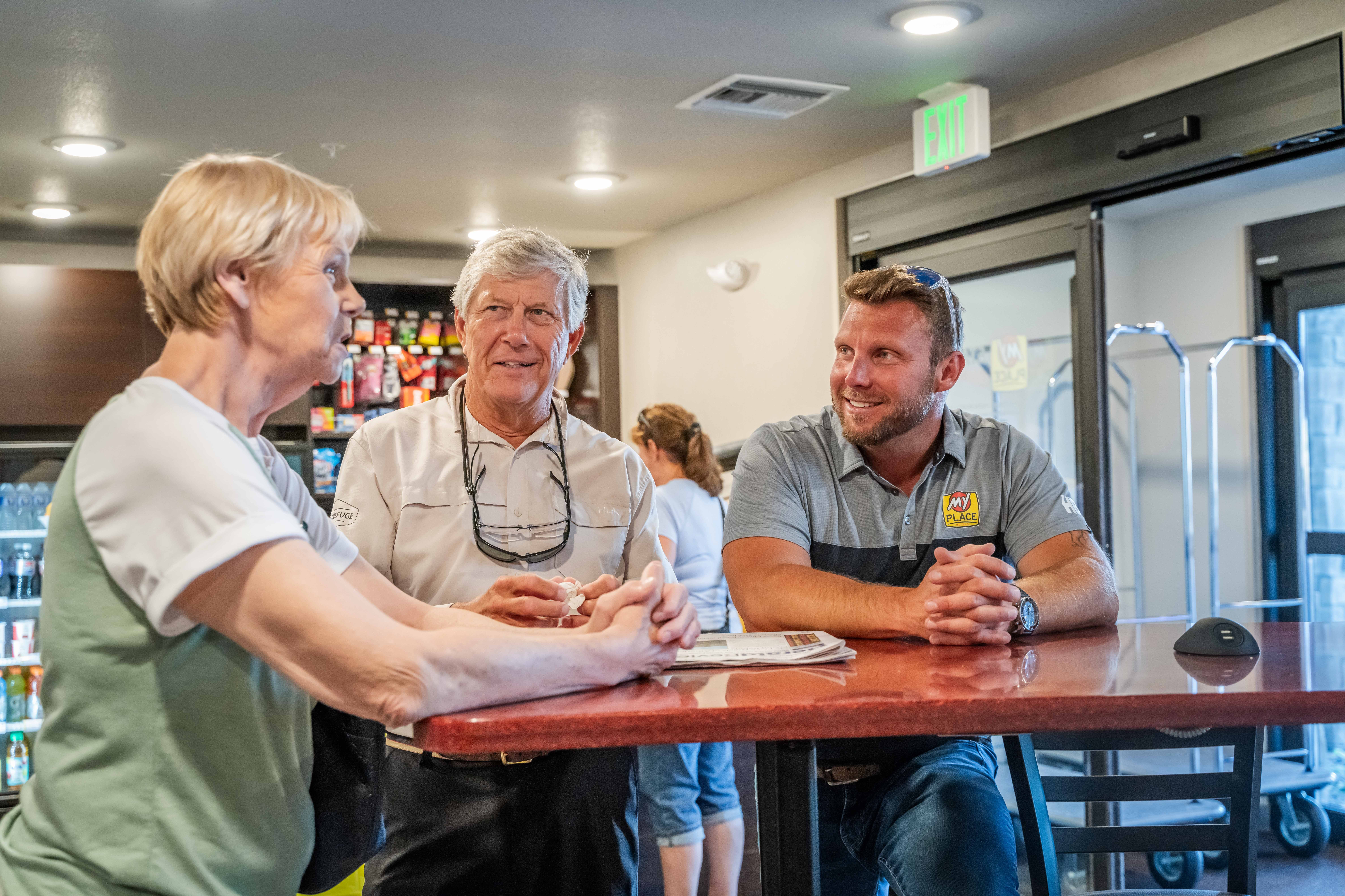 A group of people speaking in a hotel lobby