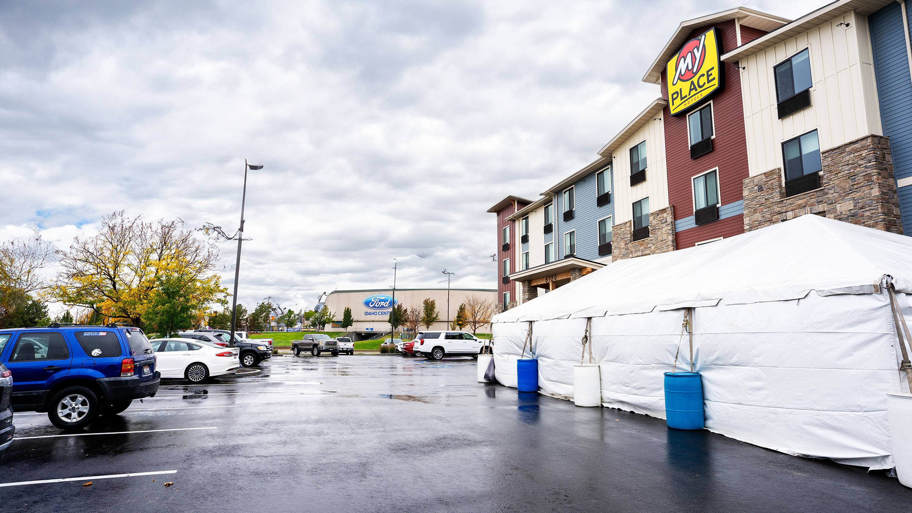 Exterior hotel parking lot showing the Ford Center next door, with a white tent in the parking lot.