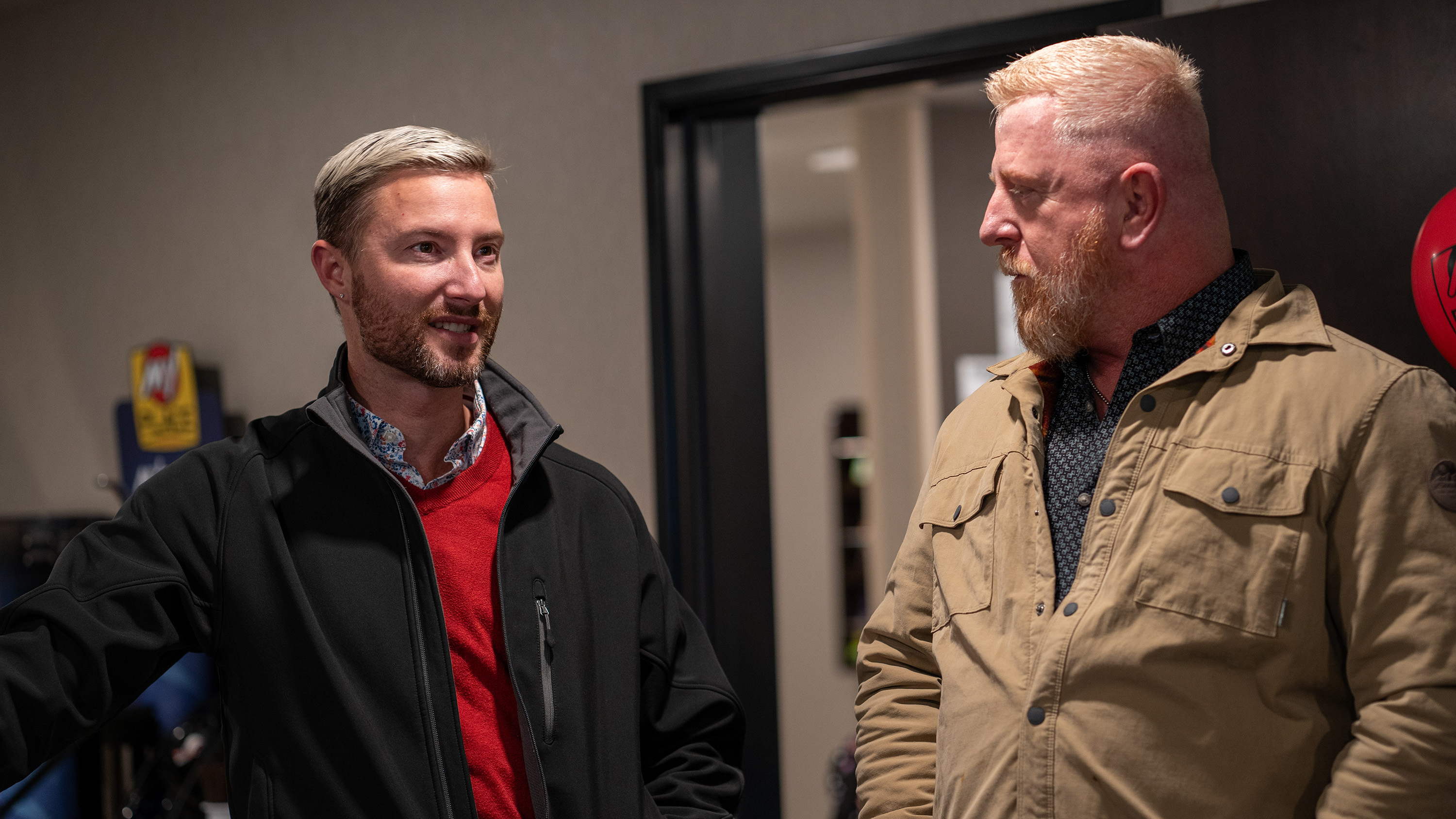 Two men talk to each other inside the hotel's lobby.