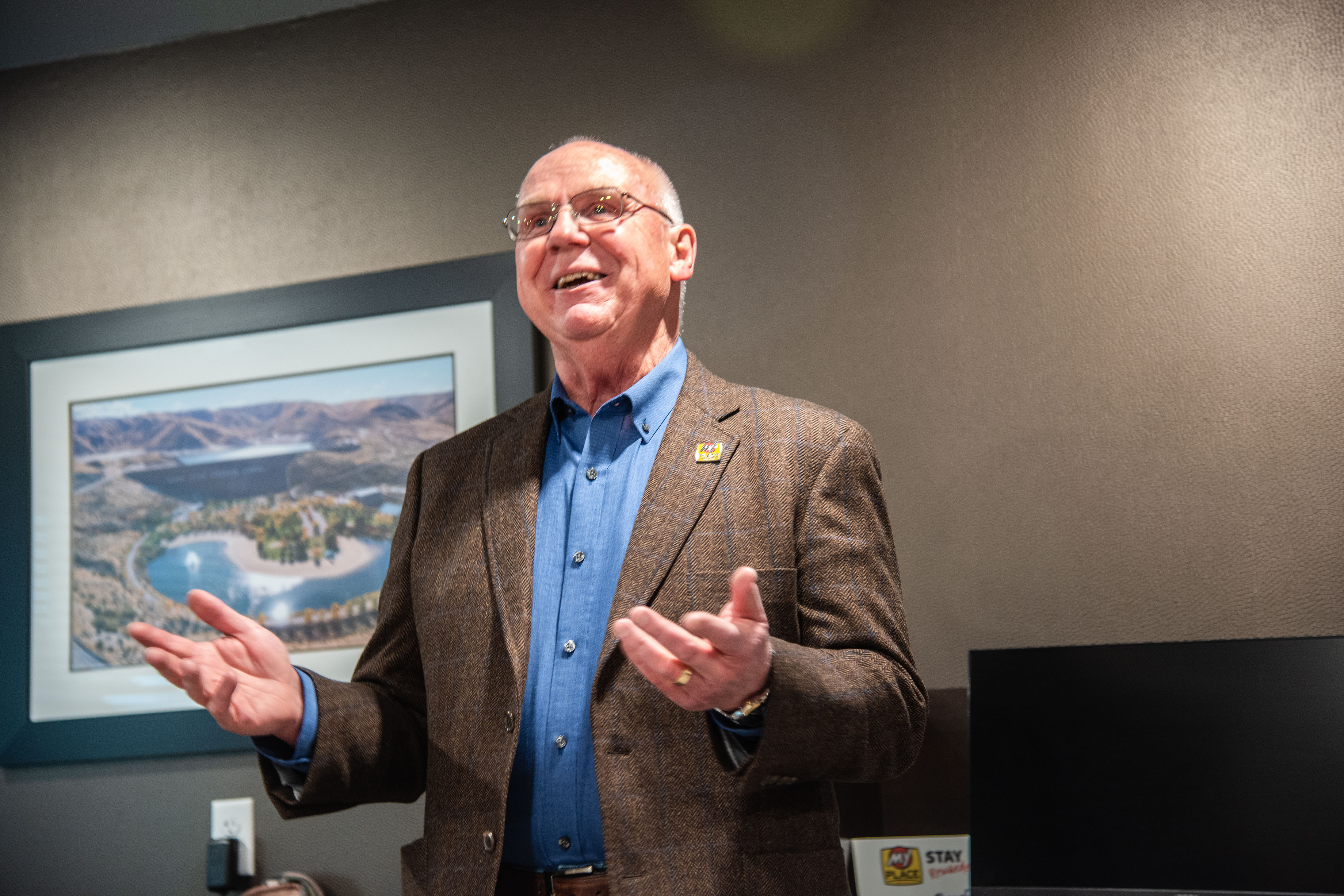 EVP of Franchise Development, Terry Kline, gestures with his hands while talking in the hotel lobby.