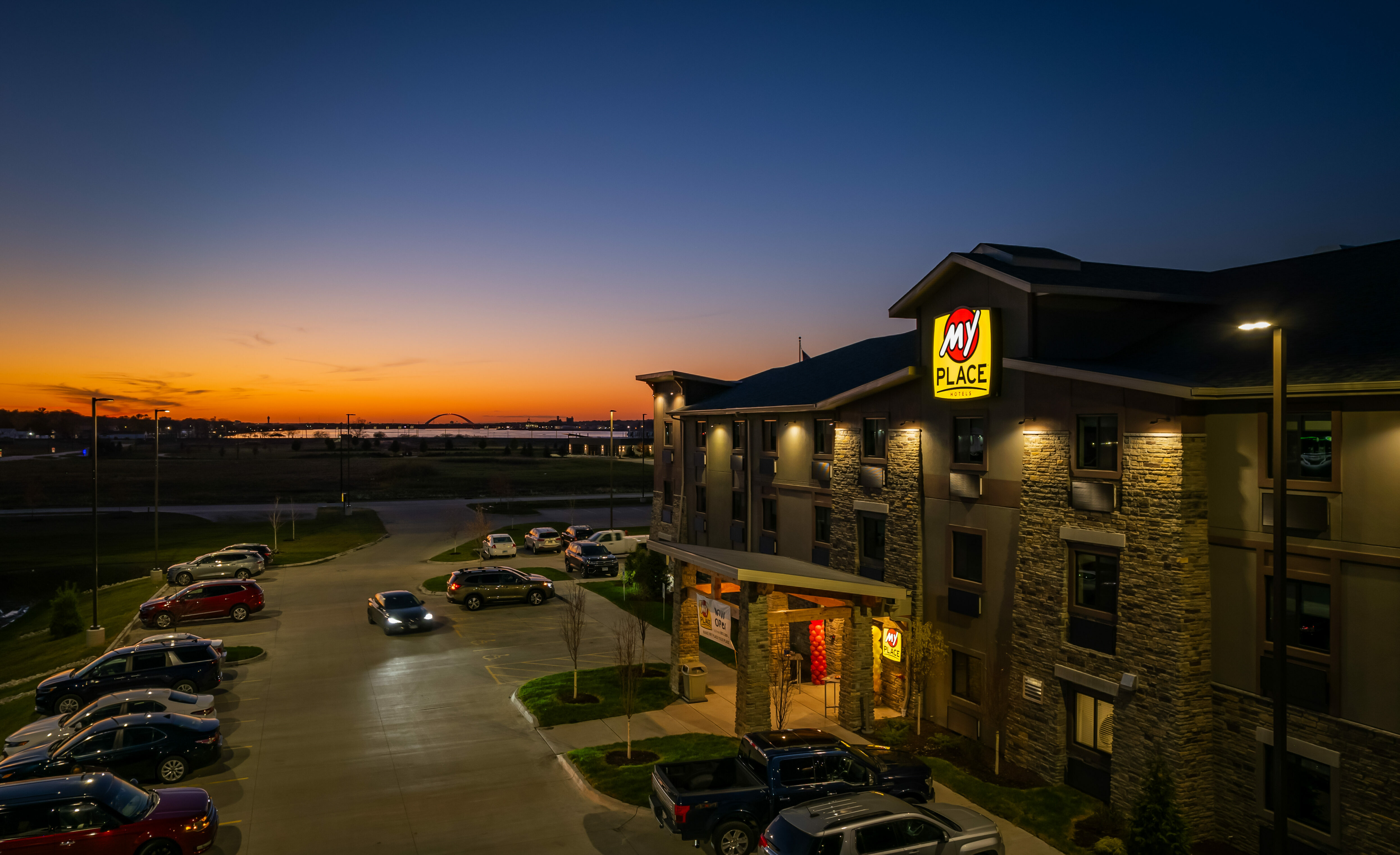 A drone shot of the hotel's exterior showing an orange sunset in the background.