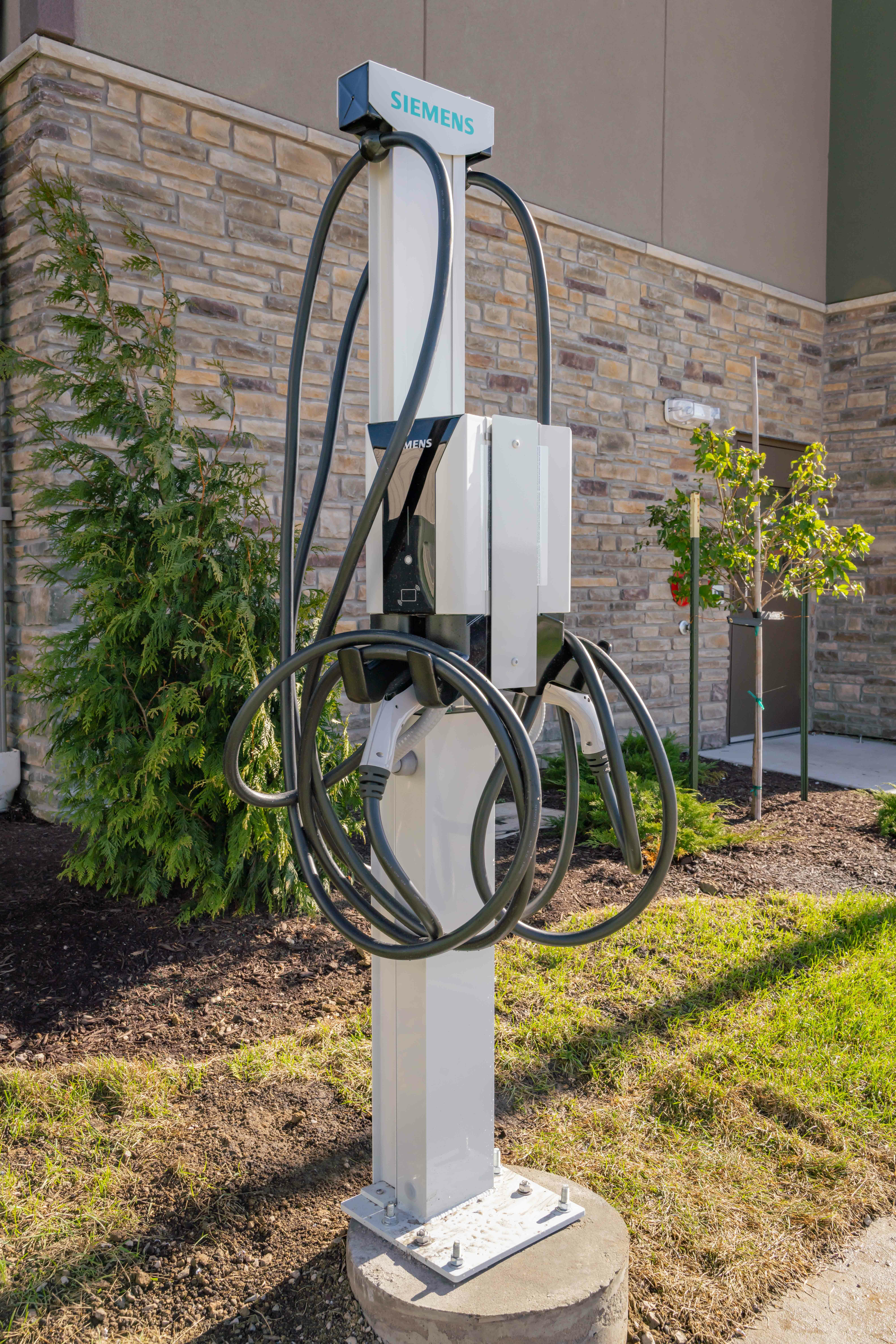 Exterior of hotel featuring charging station for electric vehicles.