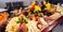 A snack board with cheese, fruit, and meat is pictured.
