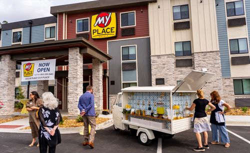 Pictured is the outside of the new My Place hotel in Pooler, while guests are standing near a food truck outside.
