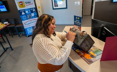 A professional is pictured signing the My Place box that fellow hotels have signed before.