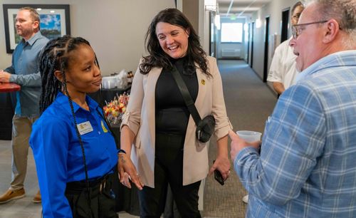 Pictured are professionals of My Place having conversations in the hallway of the new hotel.