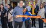 Professionals of My Place hotels are pictured holding the ribbon for the grand opening.