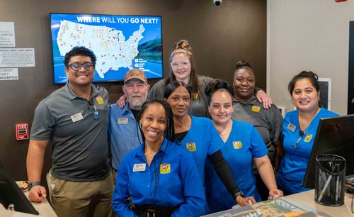 The staff of the new hotel are pictured smiling behind the new front desk.