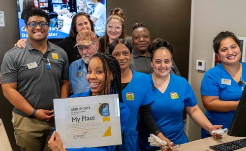Pictured is the staff of the new My Place hotel in St. Joseph, holding a certificate for the new hotel.