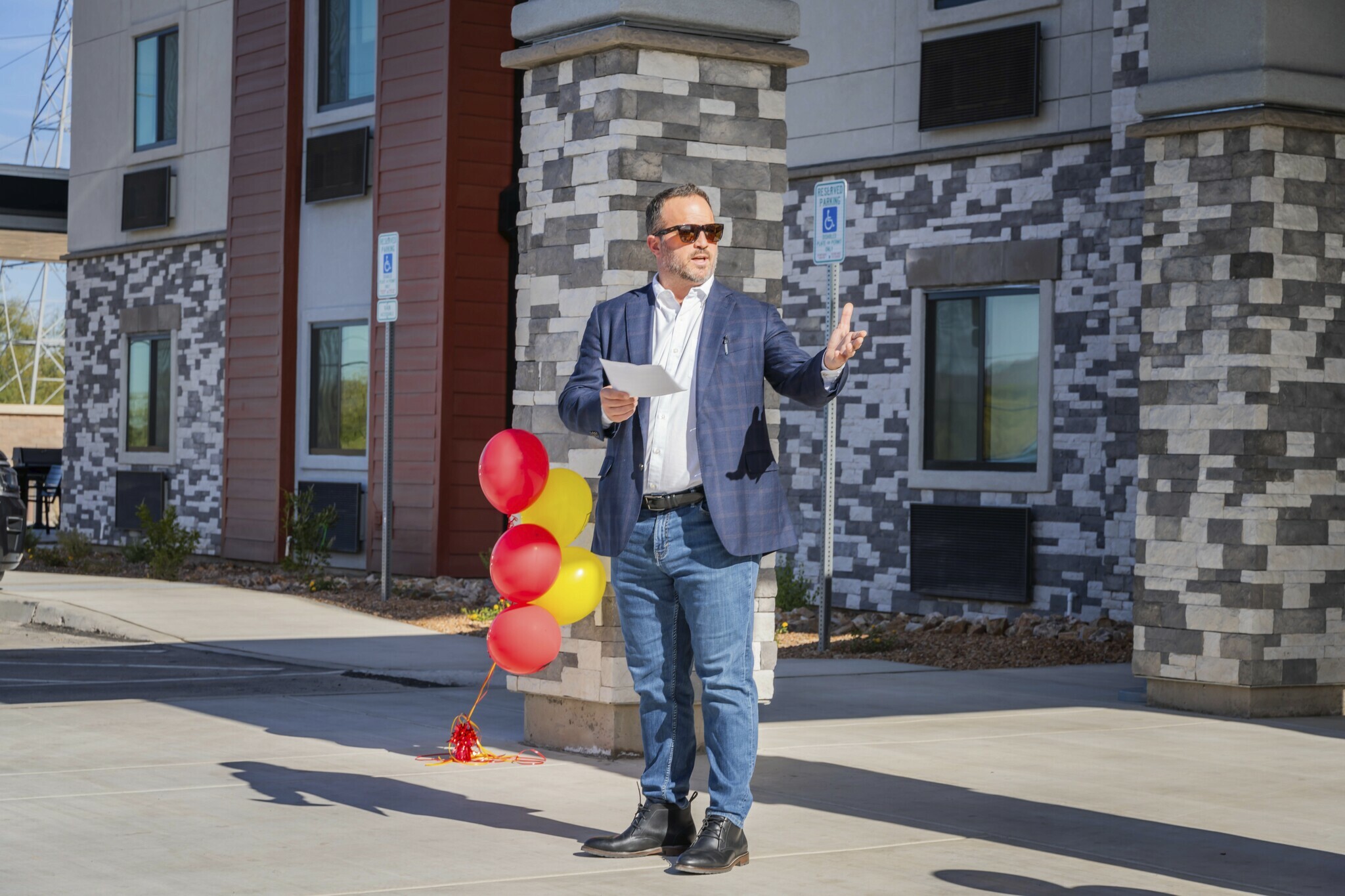 A man addresses an off-camera crowd in front of the brand new hotel in Nampa, Idaho.