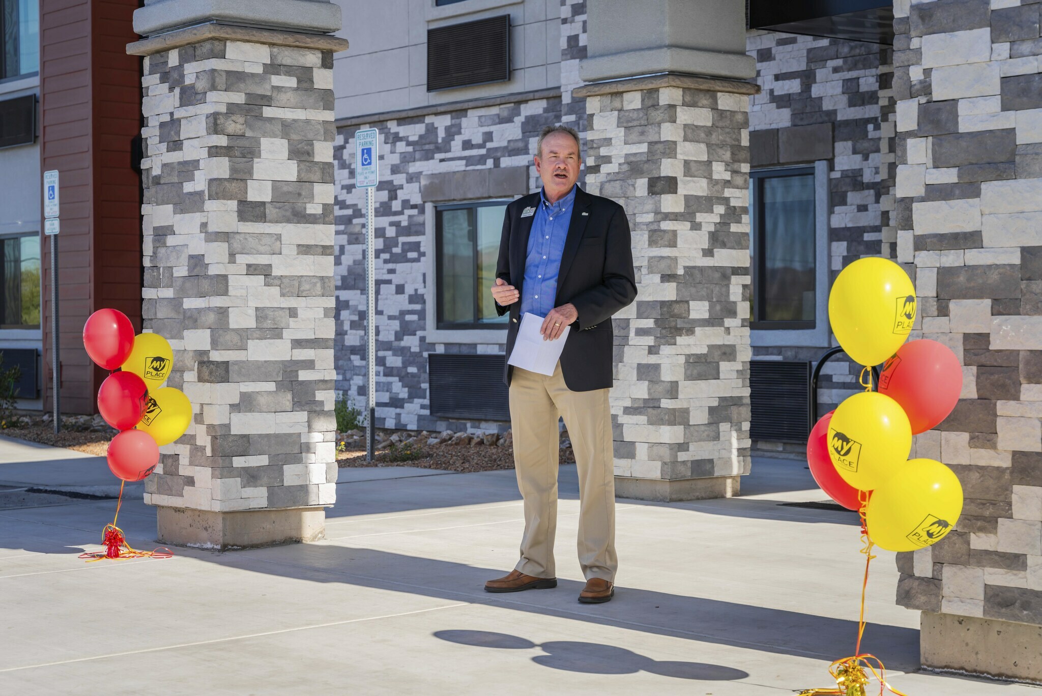 A man addresses an off-camera crowd in front of the brand new hotel in Nampa, Idaho.