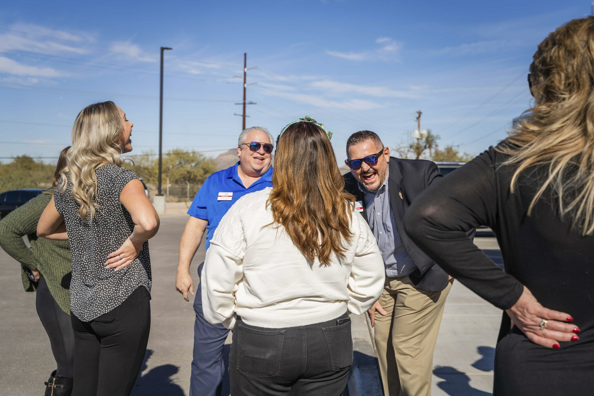 Several people talk in a group outside the new hotel in Nampa, Idaho during the hotel's grand opening celebration.