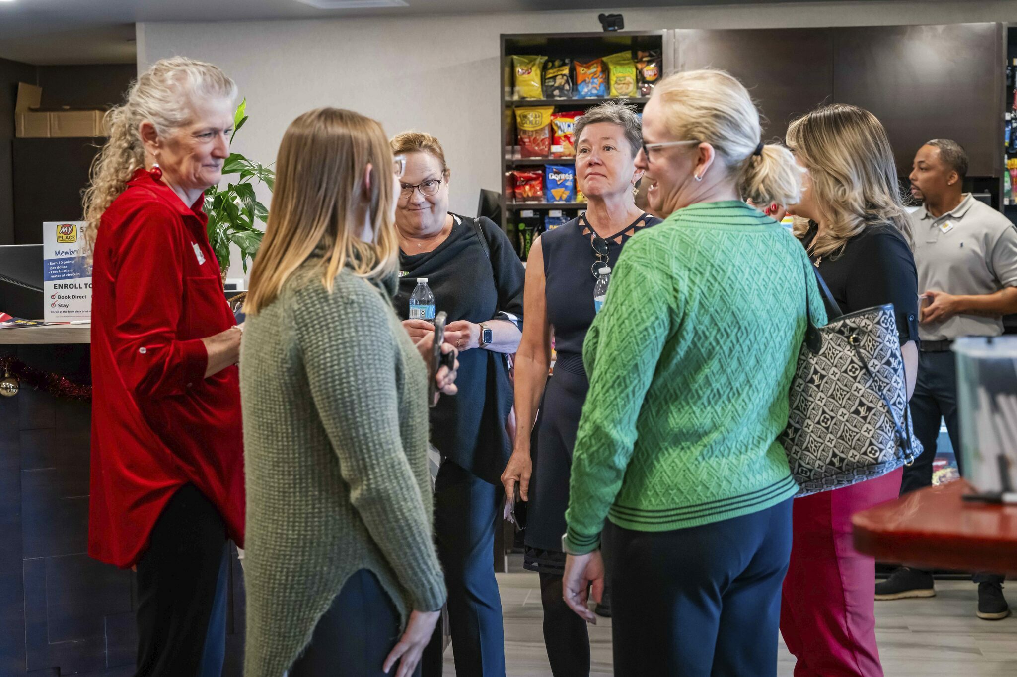 A group of women talk inside the lobby during the grand opening celebration in the new hotel in Nampa, Idaho.