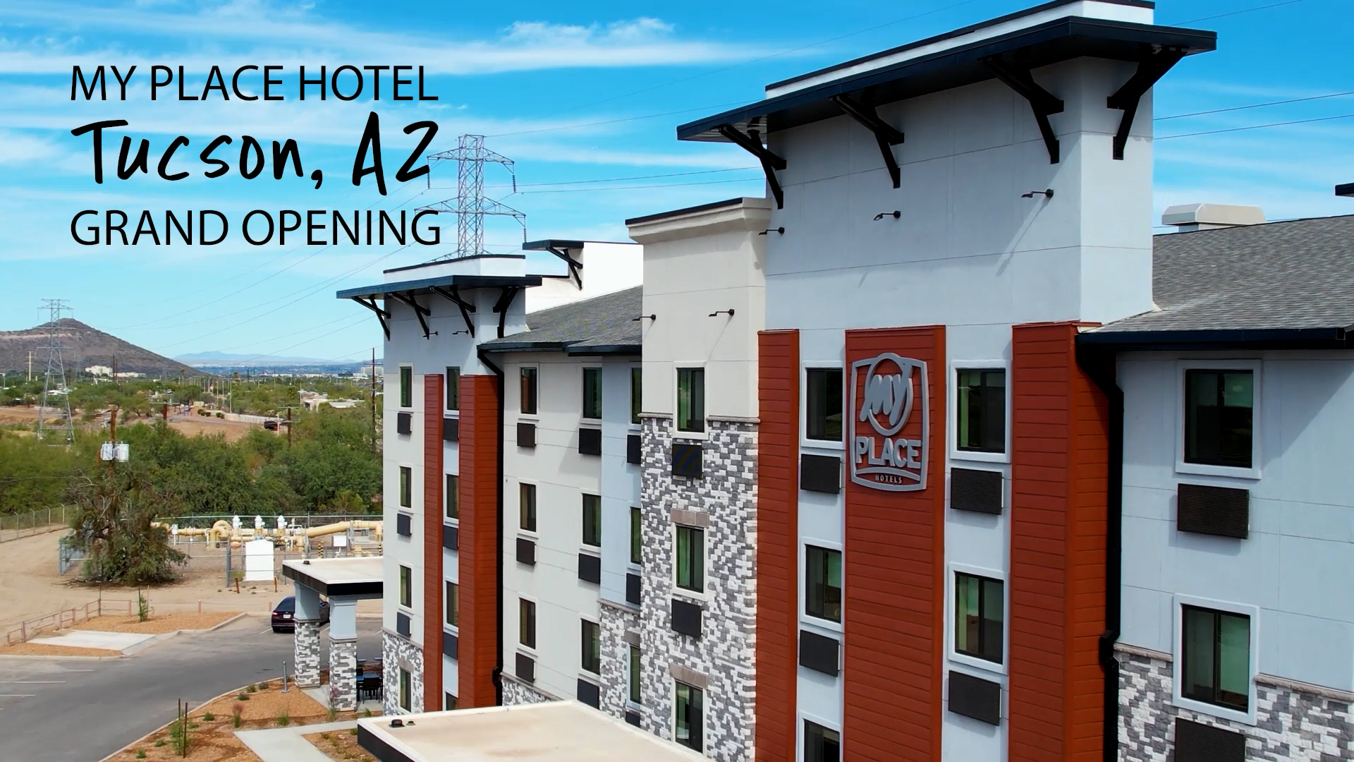 Tucson, AZ Grand Opening title screen with hotel exterior under a blue sky.