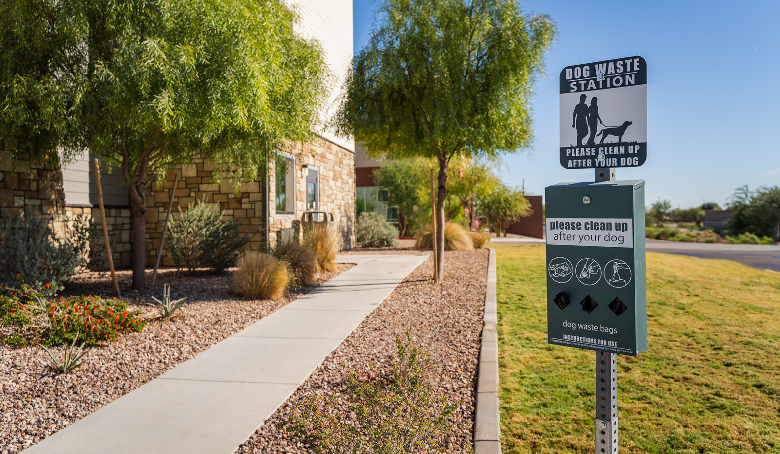 Dog waste station located on the side of the building.
