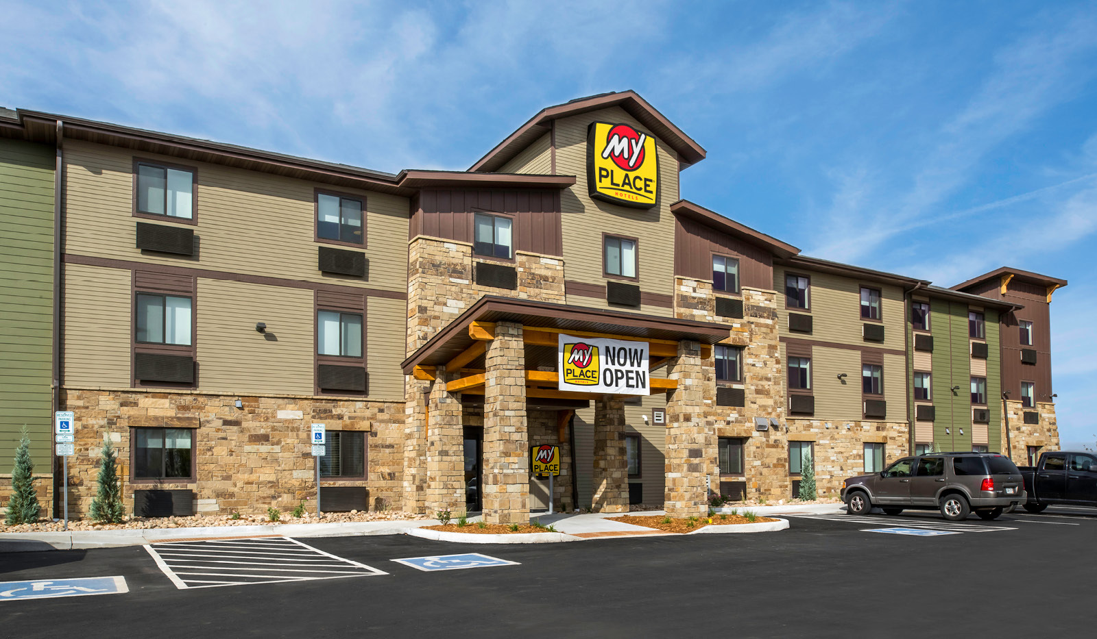 Front of property with accessible parking and entrance.